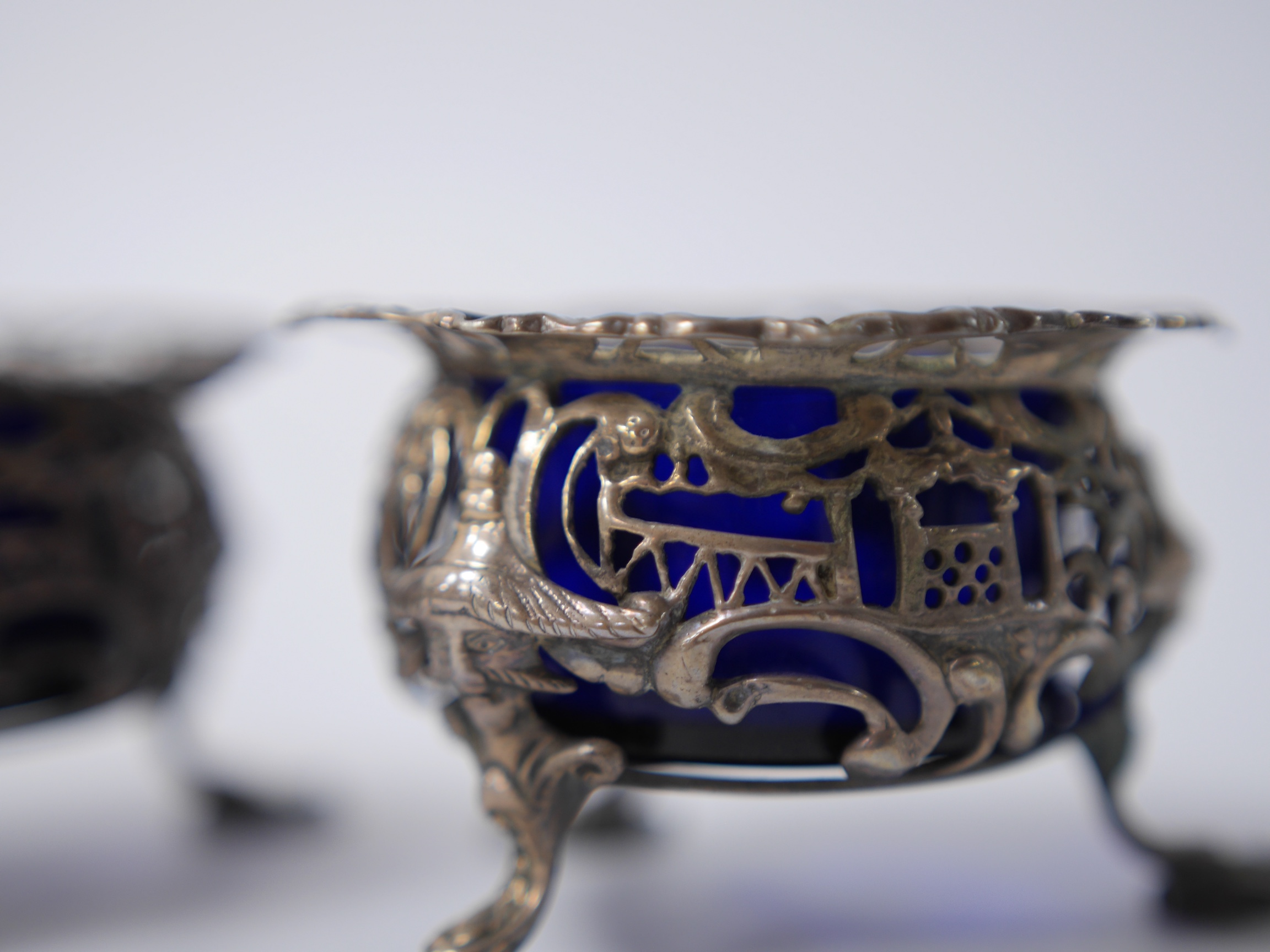 A pair of early Victorian pierced silver circular salts, with mask knees and scroll pad feet, John Wellby, London, 1841, diameter 77mm. Condition - fair